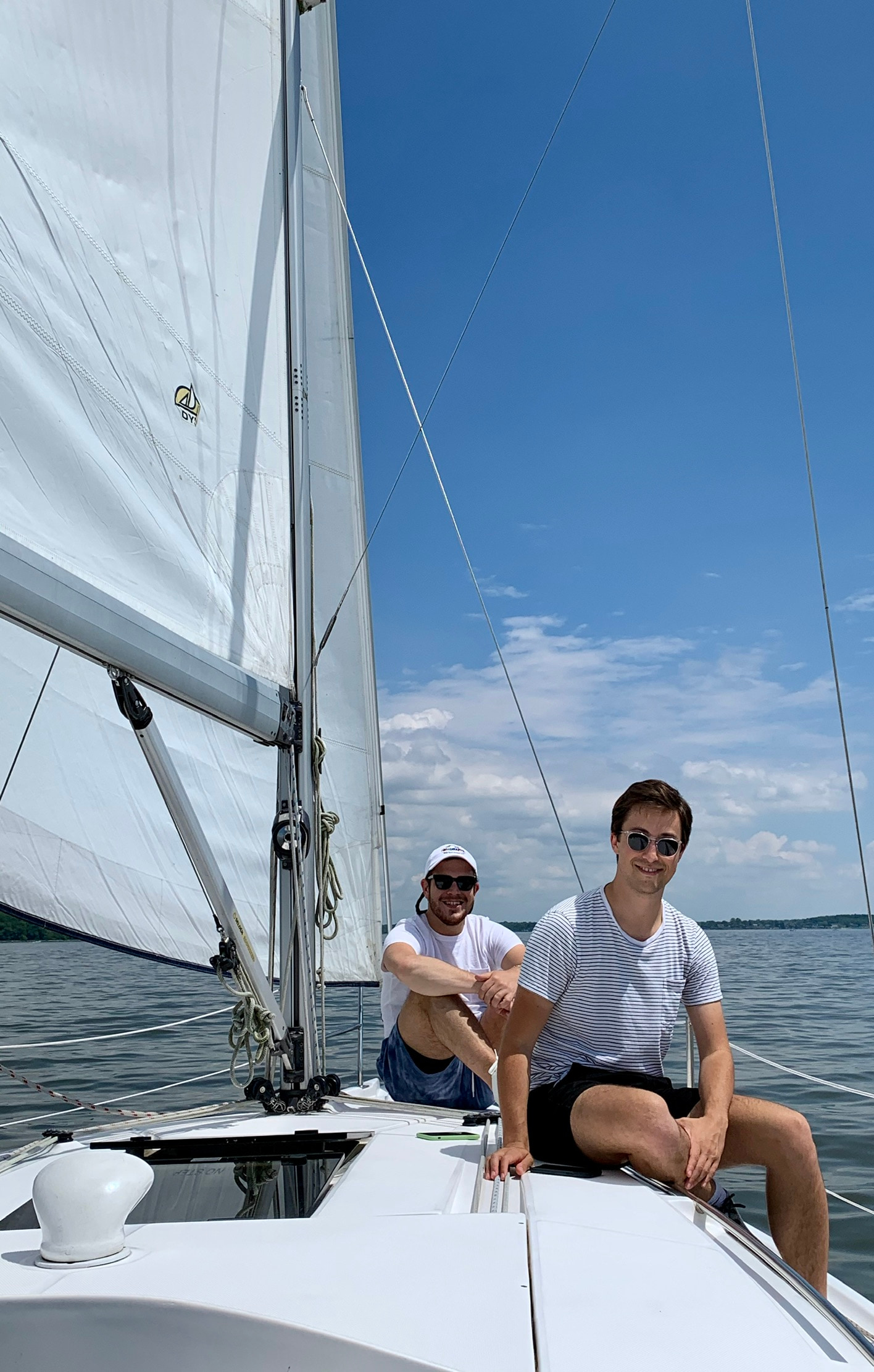 Phil and Zack sitting together on a sailboat in Annapolis