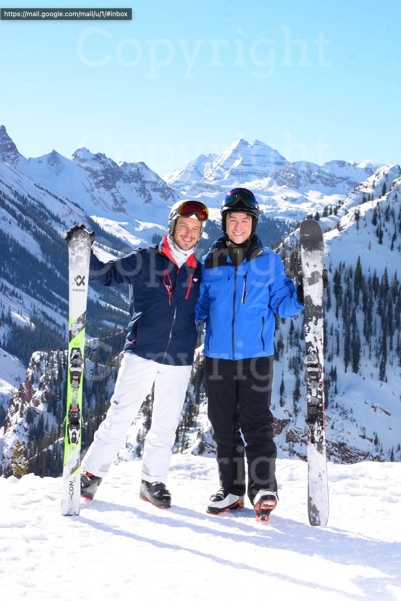 Phil and Zack holding their skis in Aspen