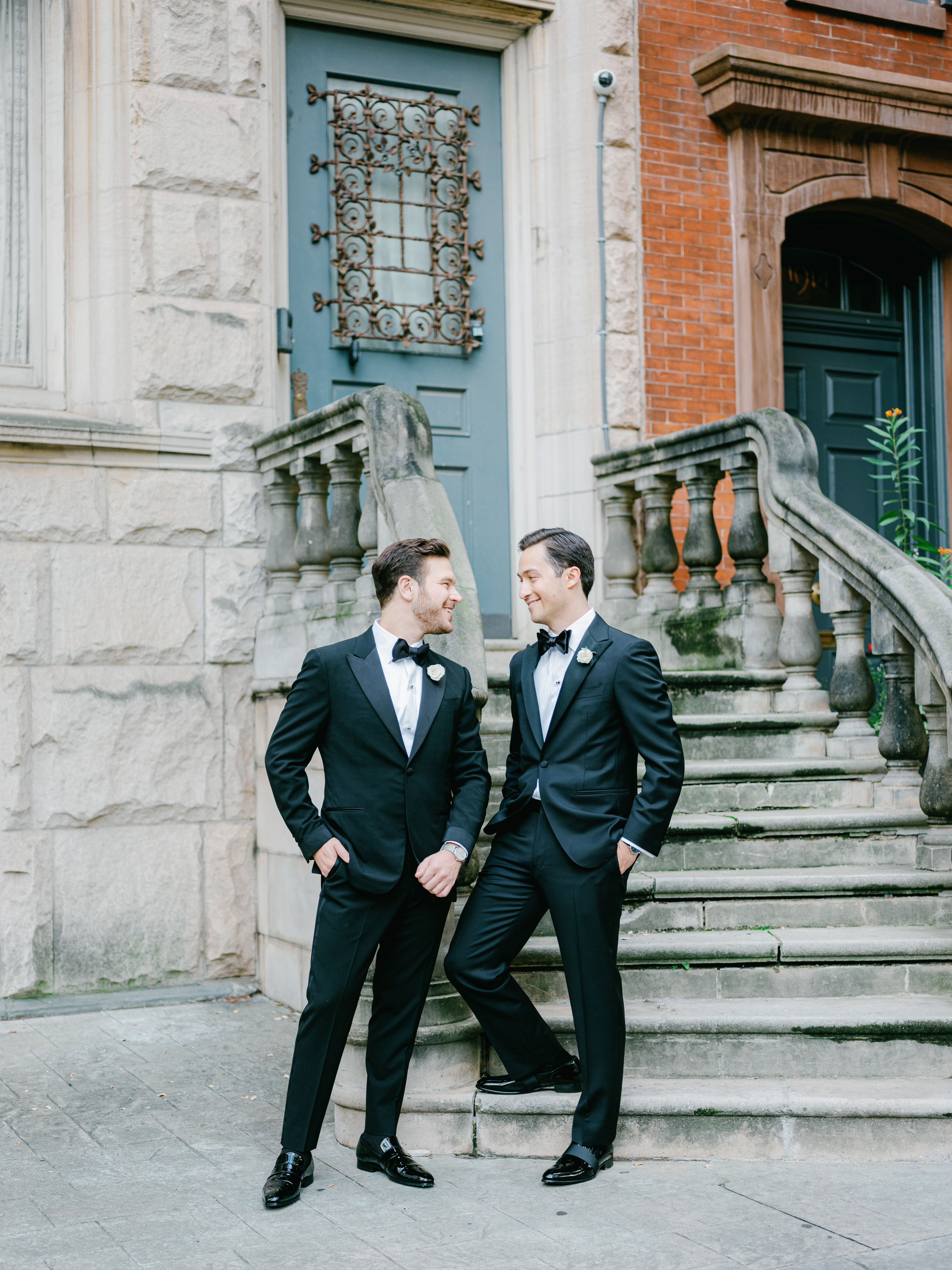 Phil and Zack holding hands outside on their wedding day