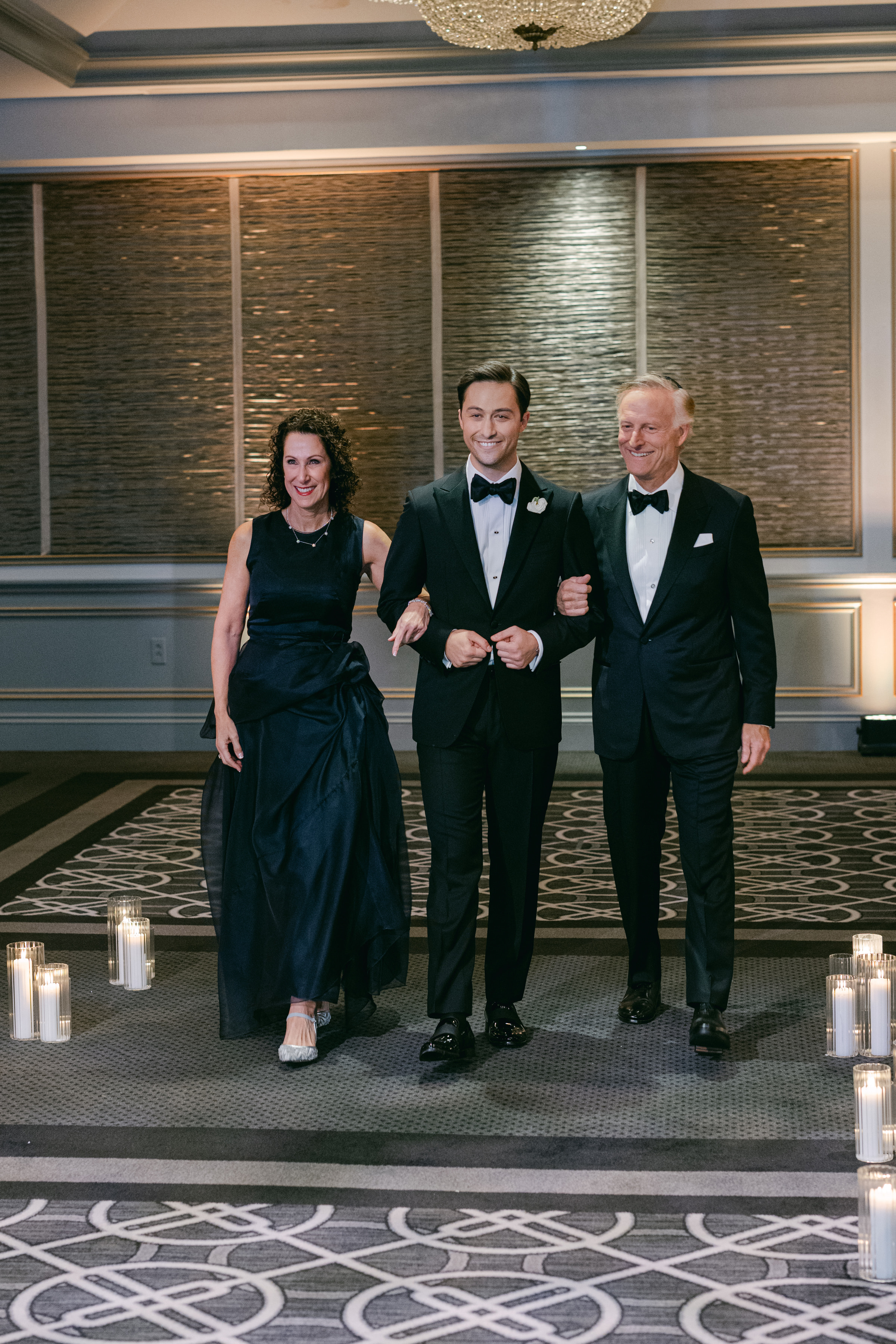 Phil walking into the wedding with his parents